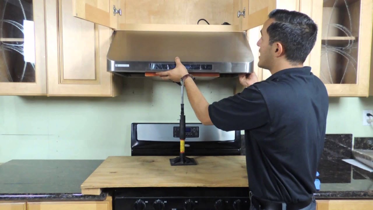 Kitchen hood installer working on commercial extraction system in Bicester